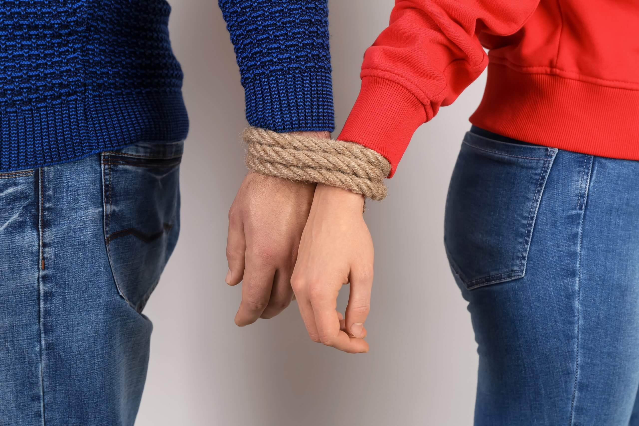 couple with wrists tied