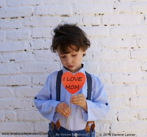 unhappy boy holding heart